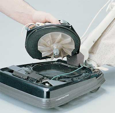 Servicing an upright vacuum's motor and dirt fan.